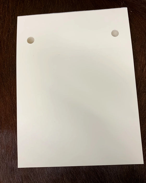 A blank 125-page notepad refill pad, punched to fit the B7 notepad cover, on a dark hide.