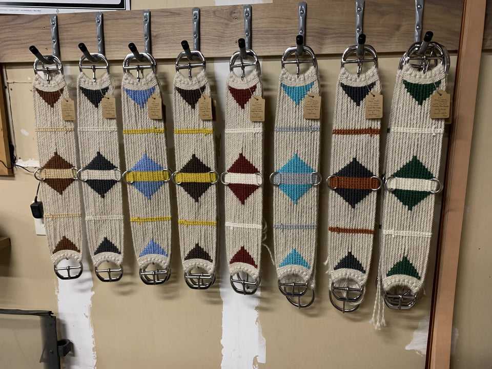Hand-tied mohair cinches in several colour pairs, hanging together.