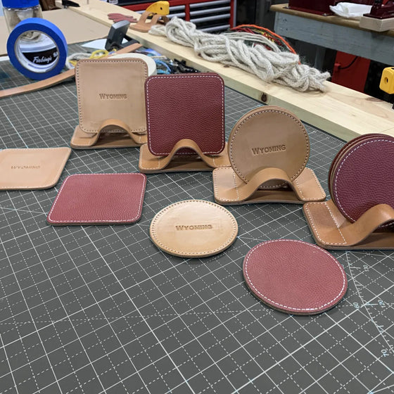 Hermann Oak leather coasters, round and square, with their stitched stands.