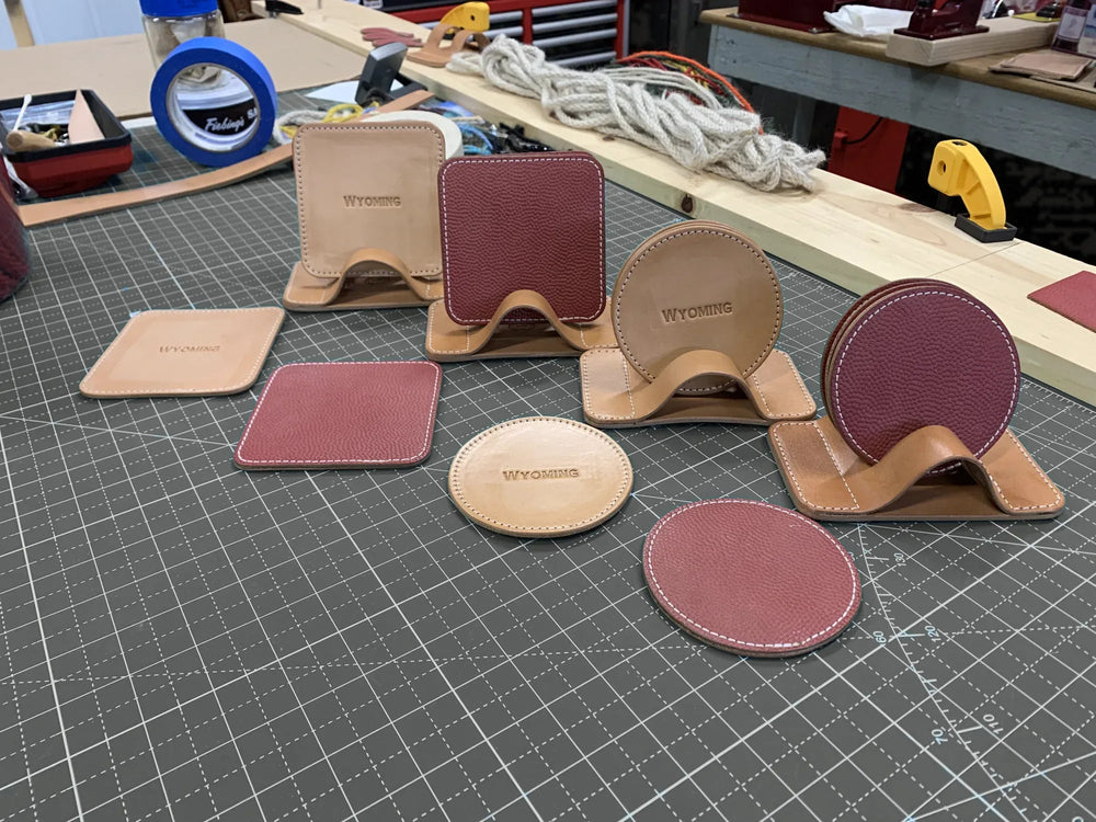 Hermann Oak leather coasters, round and square, with their stitched stands.