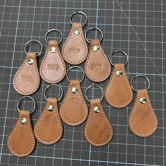 Leather key fobs with brass hardware, hand-stamped 307.